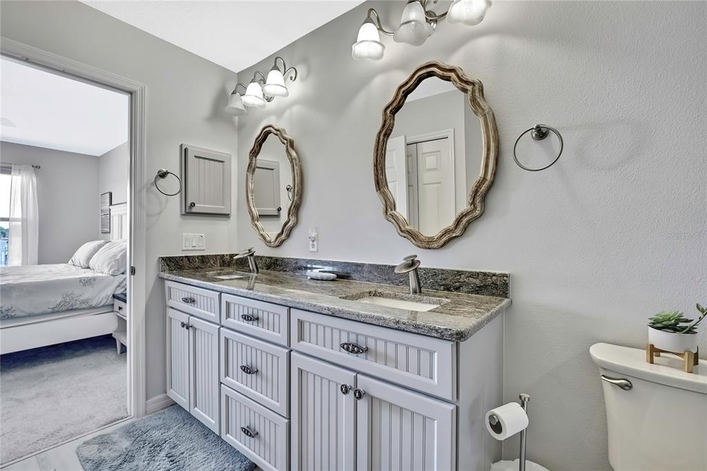 2855 North Rivers Edge Boulevard, Unit 213 Crystal River, FL 34429 - Photo 28 of 62 a bathroom with a granite countertop double vanity sink and a mirror