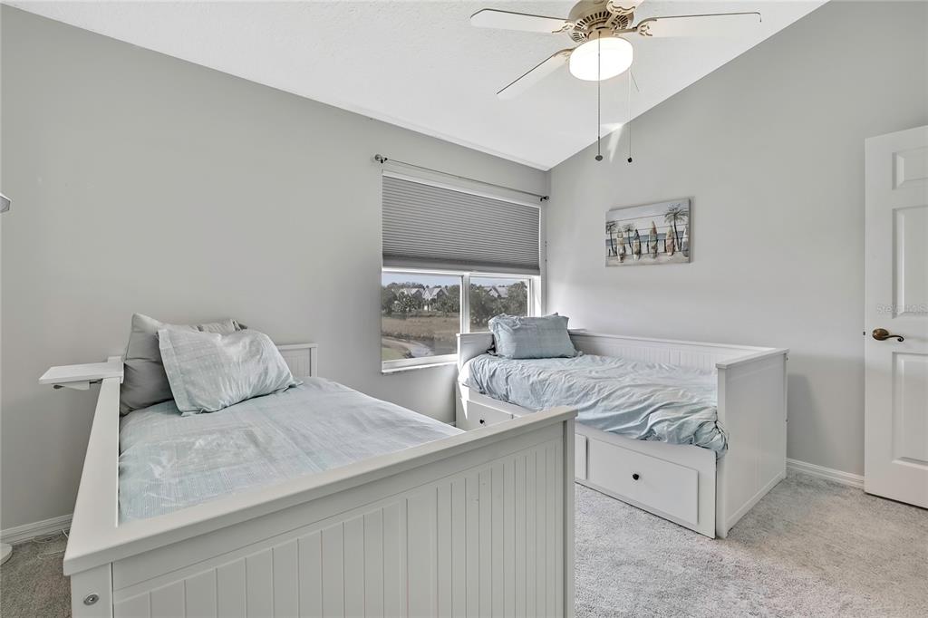 2855 North Rivers Edge Boulevard, Unit 213 Crystal River, FL 34429 - Photo 33 of 62 a bedroom with a bed and a chandelier