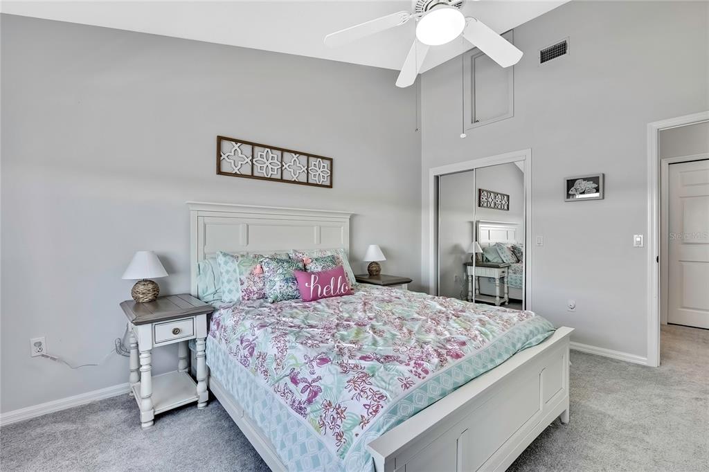 2855 North Rivers Edge Boulevard, Unit 213 Crystal River, FL 34429 - Photo 37 of 62 a bedroom with a bed and a chandelier