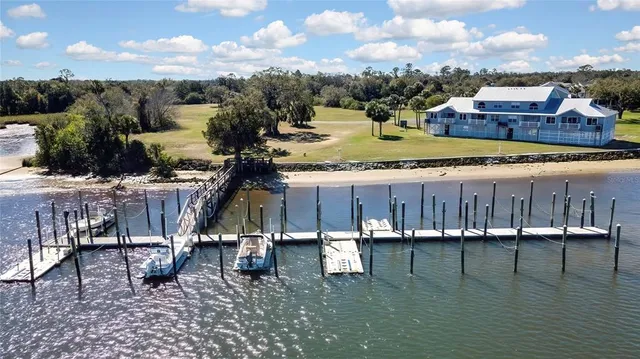 an aerial view of a house with a yard wooden table and chairs