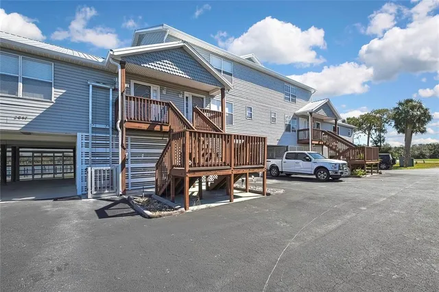 a view of backyard with deck and seating area