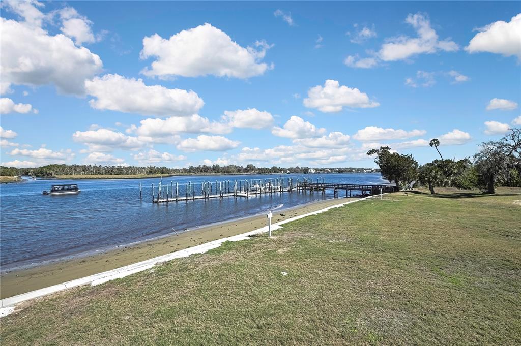 2855 North Rivers Edge Boulevard, Unit 213 Crystal River, FL 34429 - Photo 42 of 62 a view of a lake with a yard