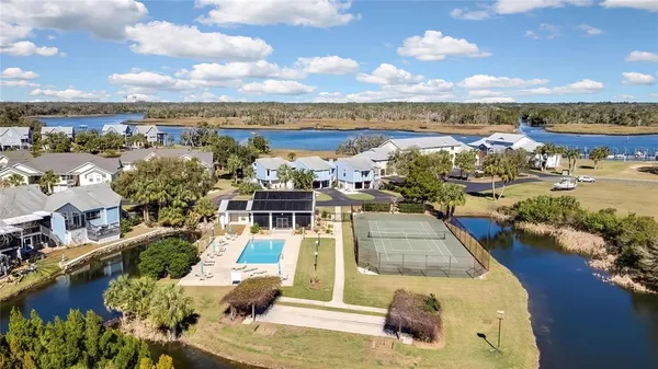 an aerial view of a house with a yard and lake view