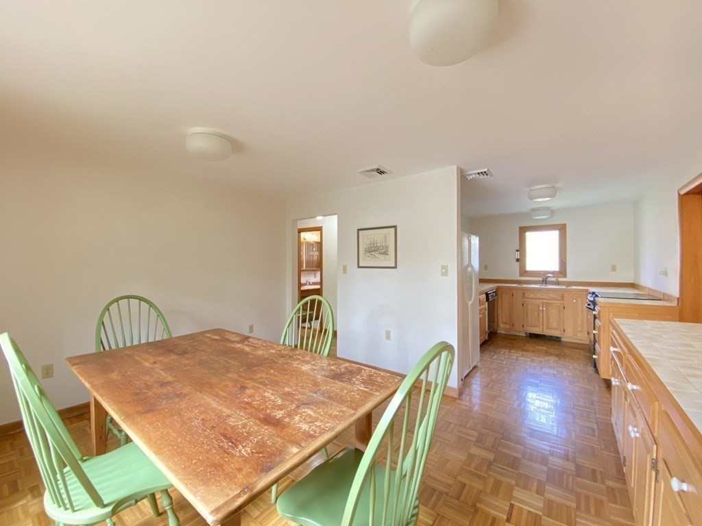 117 Rock O'Dundee Road Dartmouth, MA 02748 - Photo 12 of 24 a dining room with a table and chairs