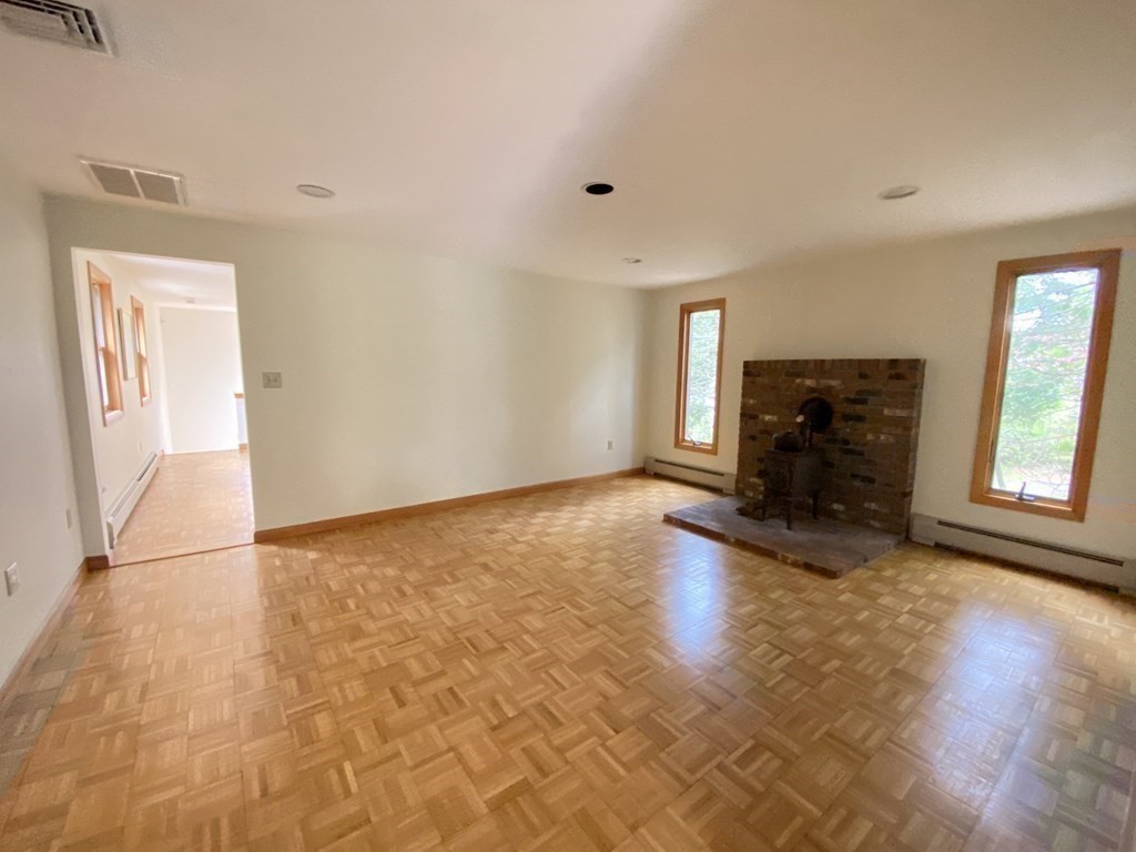 117 Rock O'Dundee Road Dartmouth, MA 02748 - Photo 3 of 24 a view of empty room with wooden floor and fireplace