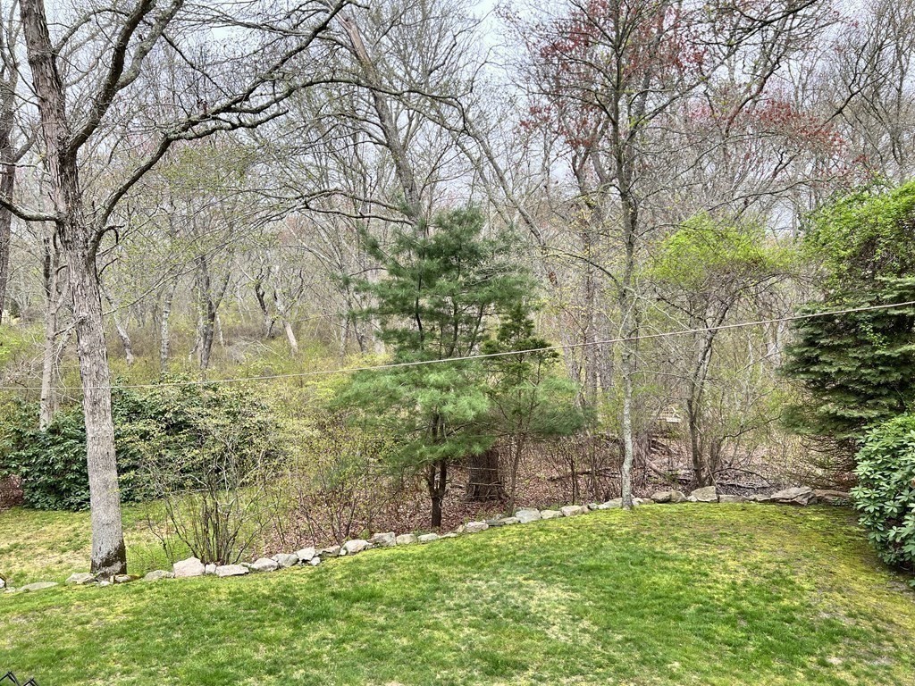 117 Rock O'Dundee Road Dartmouth, MA 02748 - Photo 4 of 24 a backyard of a house with lots of green space and fountain