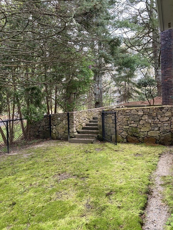 117 Rock O'Dundee Road Dartmouth, MA 02748 - Photo 7 of 24 a view of a yard with wooden fence
