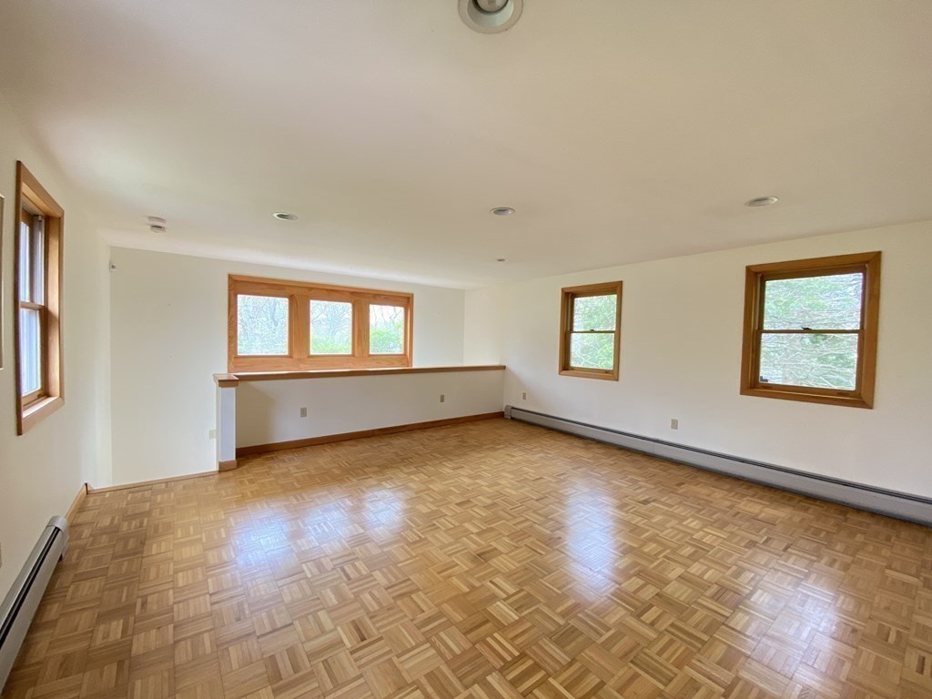 117 Rock O'Dundee Road Dartmouth, MA 02748 - Photo 8 of 24 a view of an empty room with a window and wooden floor