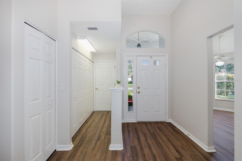 11718 Wheatfield Loop Hudson, FL 34667 - Photo 13 of 88 a view of a hallway with wooden floor and staircase