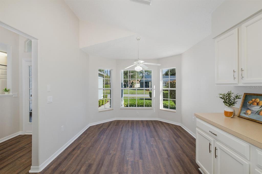11718 Wheatfield Loop Hudson, FL 34667 - Photo 15 of 88 a view of an empty room with wooden floor and a window