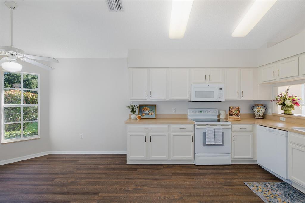 11718 Wheatfield Loop Hudson, FL 34667 - Photo 16 of 88 a kitchen with stainless steel appliances granite countertop a stove a sink and white cabinets