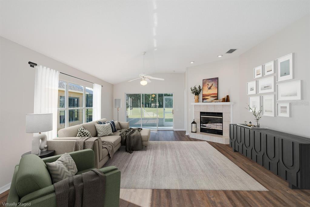 11718 Wheatfield Loop Hudson, FL 34667 - Photo 21 of 88 a living room with furniture a fireplace and a large window