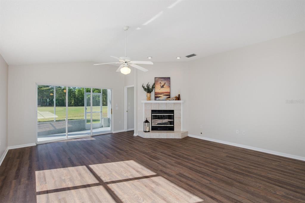 11718 Wheatfield Loop Hudson, FL 34667 - Photo 22 of 88 a view of an empty room with a fireplace and a large window