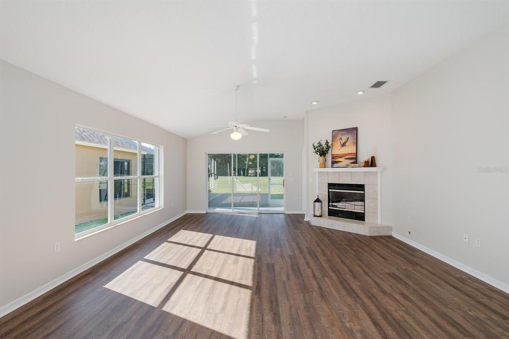 11718 Wheatfield Loop Hudson, FL 34667 - Photo 24 of 88 a view of empty room with wooden floor and fan