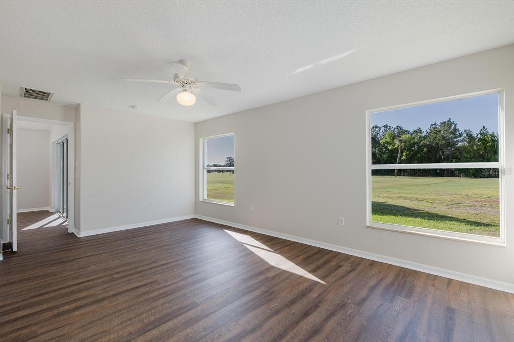 11718 Wheatfield Loop Hudson, FL 34667 - Photo 29 of 88 a view of an empty room with a window and wooden floor