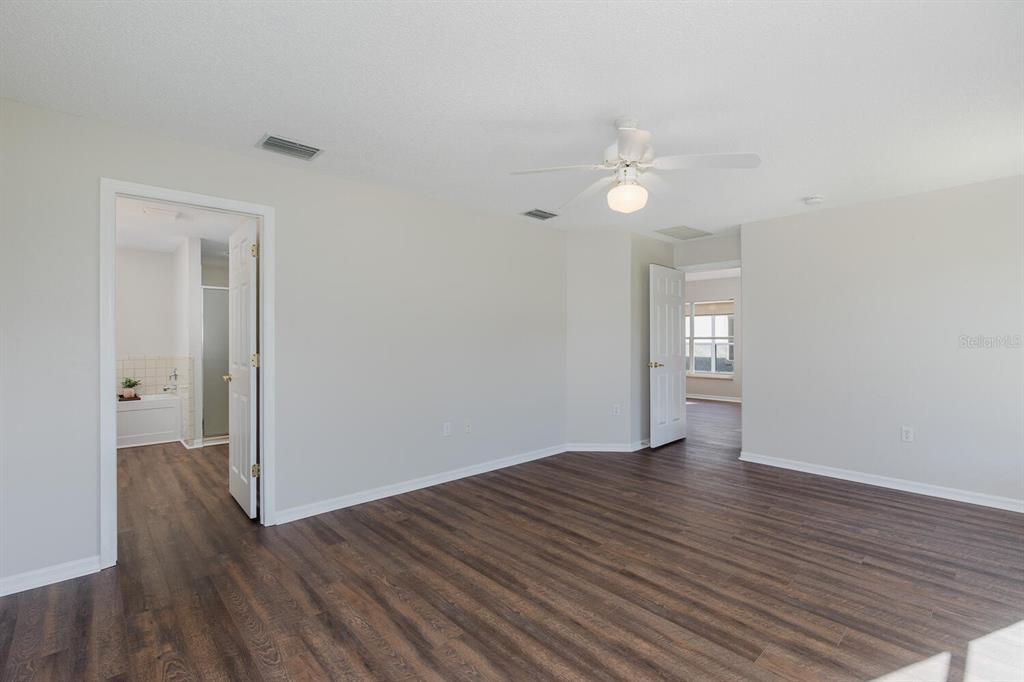 11718 Wheatfield Loop Hudson, FL 34667 - Photo 30 of 88 wooden floor in an empty room with a window