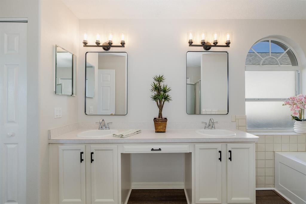 11718 Wheatfield Loop Hudson, FL 34667 - Photo 32 of 88 a bathroom with double sink and a mirror