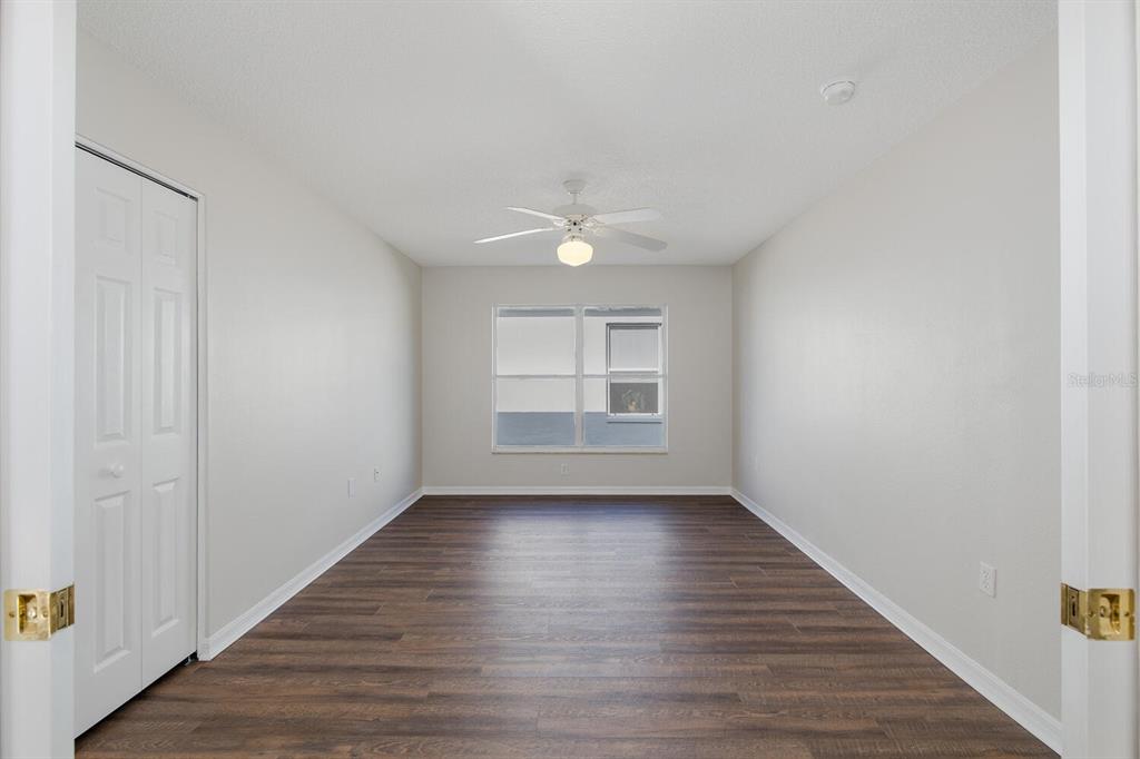 11718 Wheatfield Loop Hudson, FL 34667 - Photo 37 of 88 a view of an empty room with wooden floor and a window
