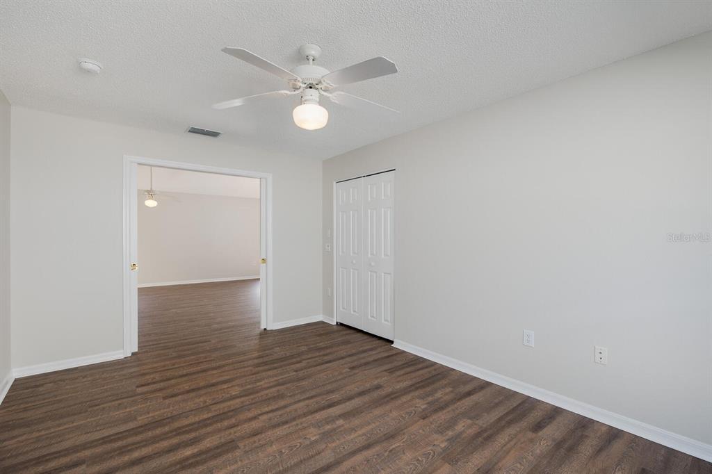 11718 Wheatfield Loop Hudson, FL 34667 - Photo 38 of 88 a view of an empty room with wooden floor