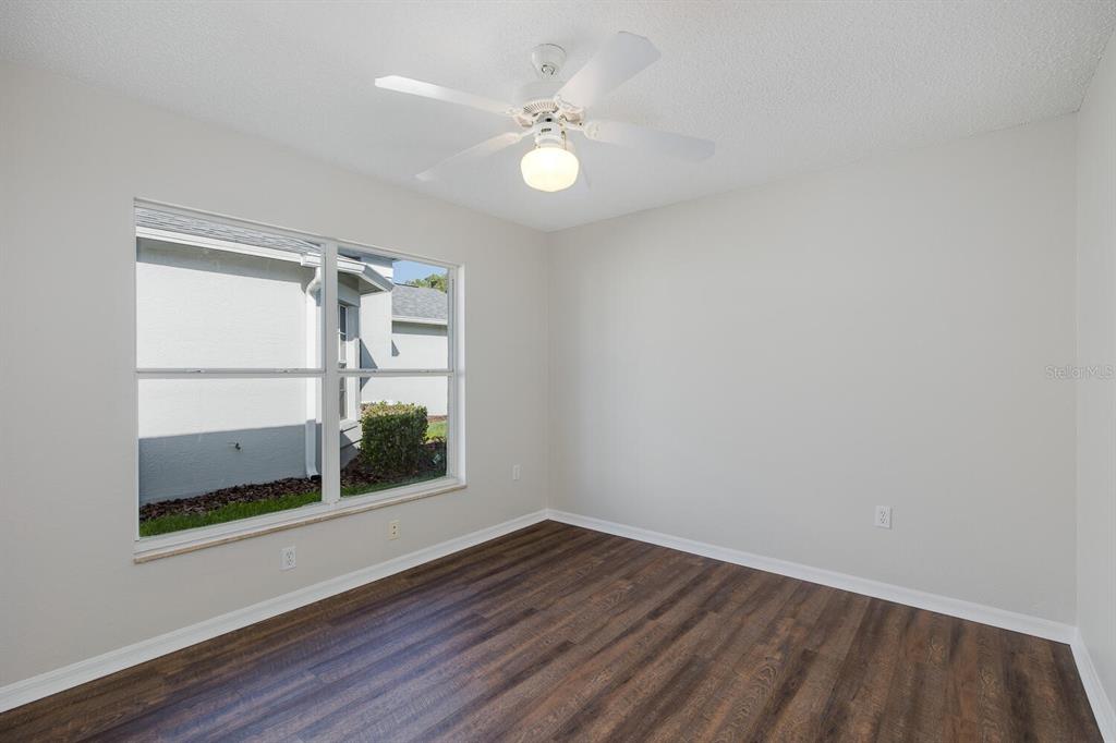 11718 Wheatfield Loop Hudson, FL 34667 - Photo 40 of 88 wooden floor in an empty room with a window