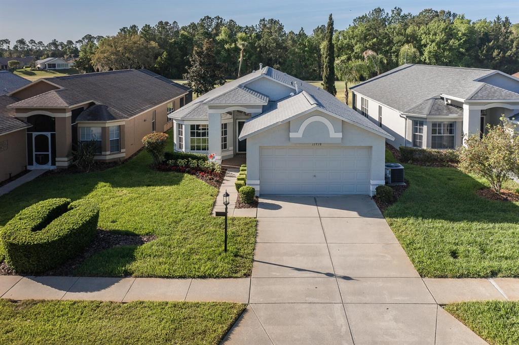 11718 Wheatfield Loop Hudson, FL 34667 - Photo 4 of 88 a aerial view of a house with a yard and potted plants