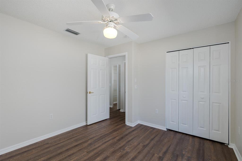 11718 Wheatfield Loop Hudson, FL 34667 - Photo 41 of 88 a view of an empty room with wooden floor
