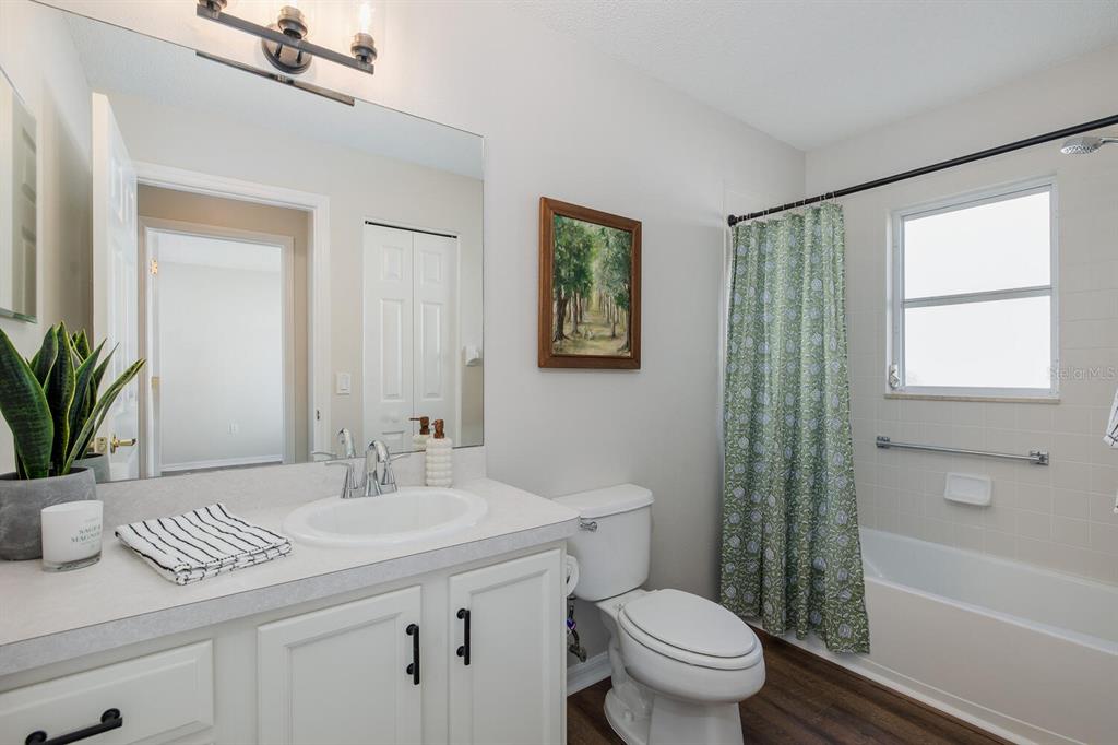 11718 Wheatfield Loop Hudson, FL 34667 - Photo 42 of 88 a bathroom with a granite countertop sink a toilet a mirror a vanity and shower