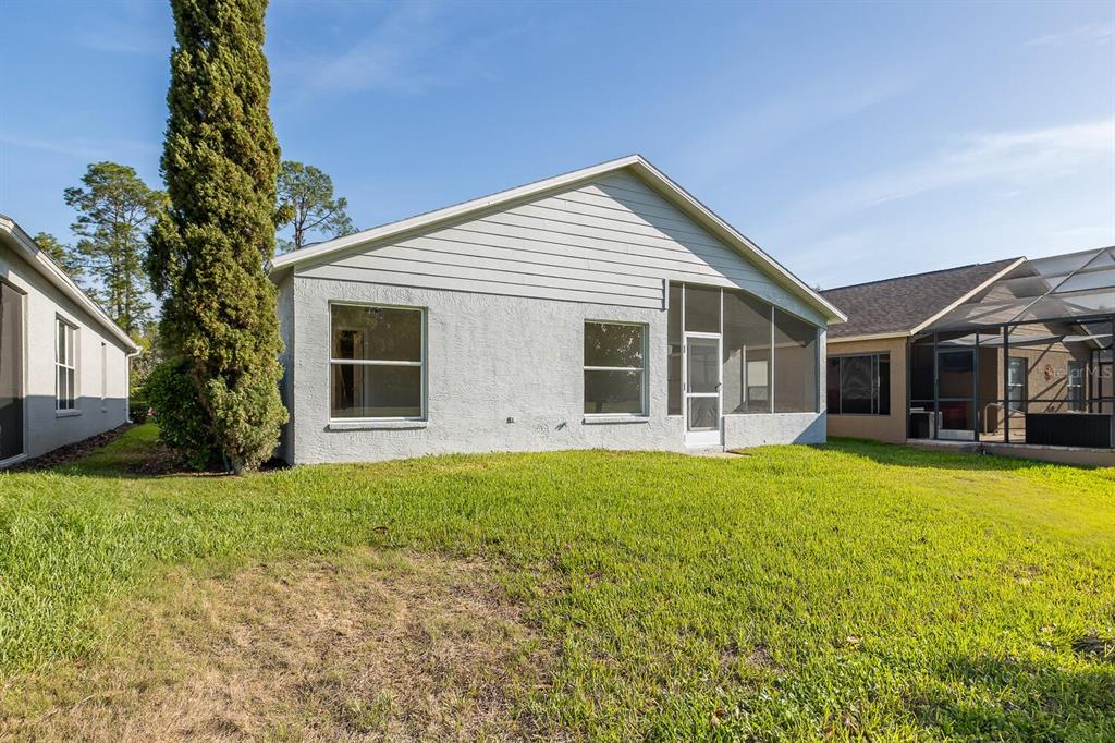 11718 Wheatfield Loop Hudson, FL 34667 - Photo 49 of 88 a front view of house with yard and green space