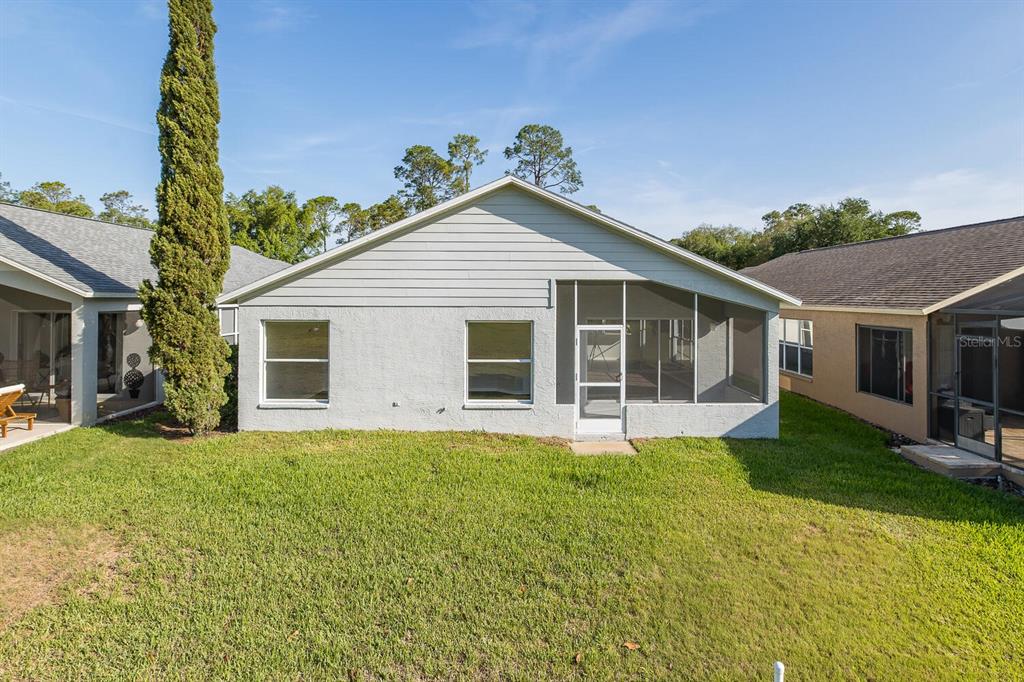 11718 Wheatfield Loop Hudson, FL 34667 - Photo 50 of 88 a view of a house with a yard and garden