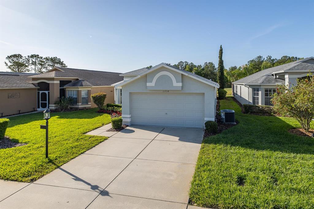 11718 Wheatfield Loop Hudson, FL 34667 - Photo 5 of 88 a front view of a house with a yard