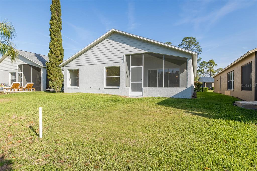 11718 Wheatfield Loop Hudson, FL 34667 - Photo 52 of 88 a front view of a house with a yard