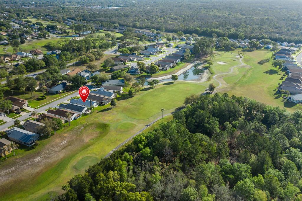 11718 Wheatfield Loop Hudson, FL 34667 - Photo 59 of 88 an aerial view of residential houses with outdoor space and trees