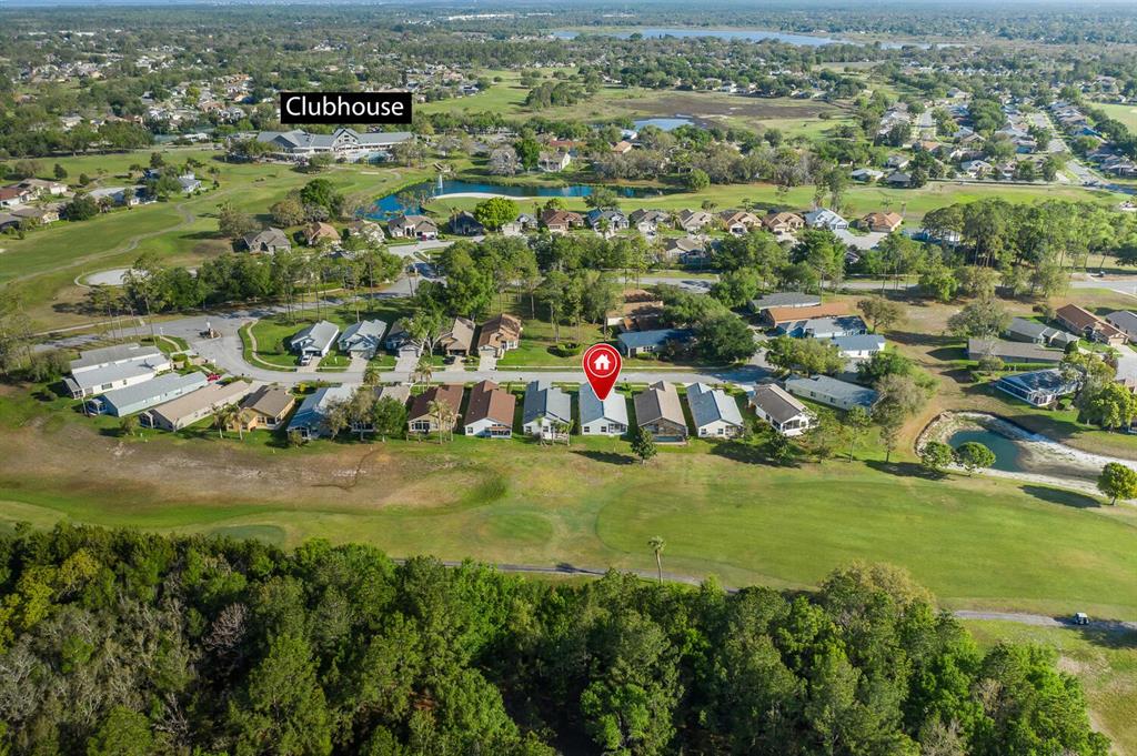 11718 Wheatfield Loop Hudson, FL 34667 - Photo 61 of 88 an aerial view of residential houses with outdoor space and trees