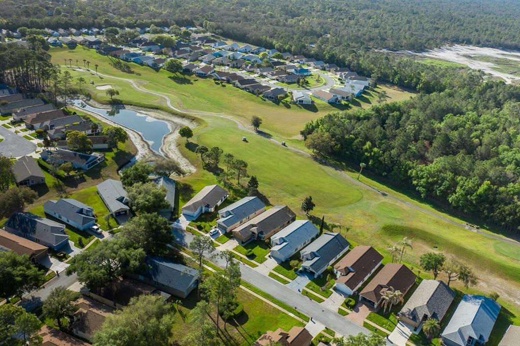 11718 Wheatfield Loop Hudson, FL 34667 - Photo 65 of 88 an aerial view of residential houses with outdoor space and swimming pool