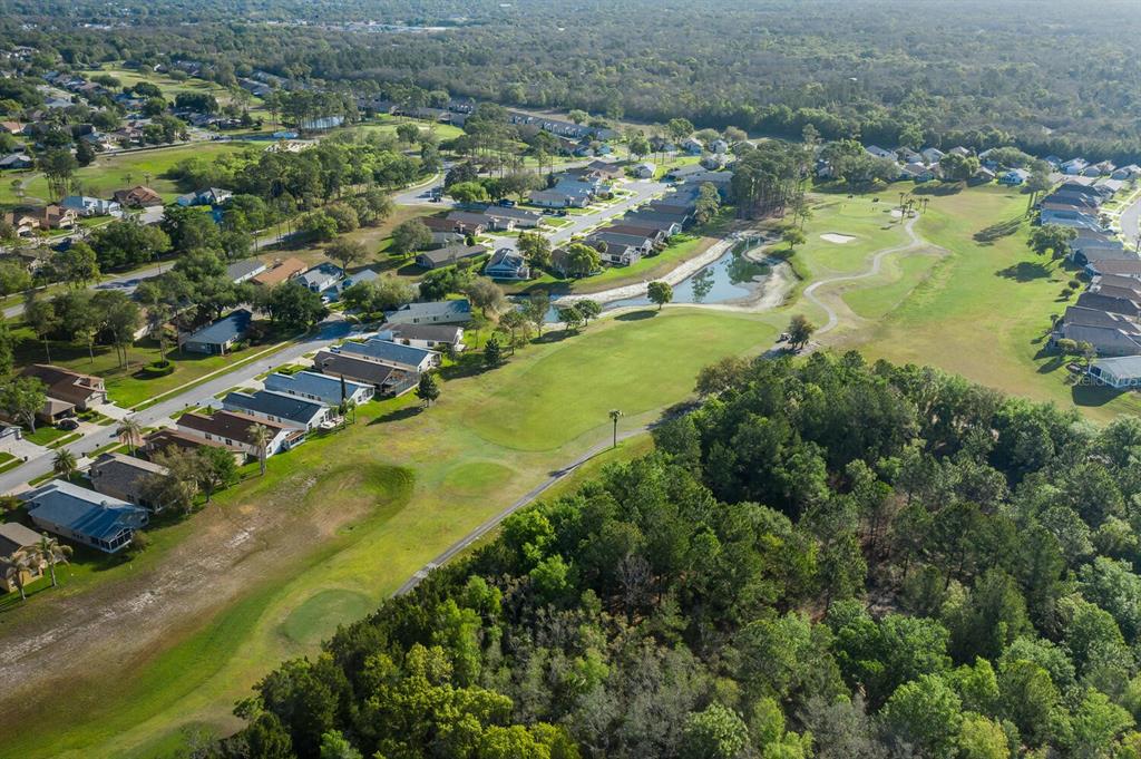 11718 Wheatfield Loop Hudson, FL 34667 - Photo 70 of 88 an aerial view of residential houses with outdoor space and trees