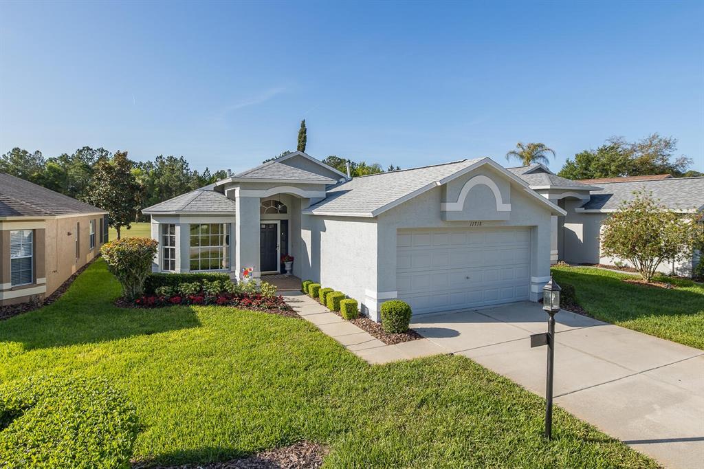 11718 Wheatfield Loop Hudson, FL 34667 - Photo 7 of 88 a front view of a house with a yard