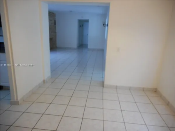 a view of an empty room with windows