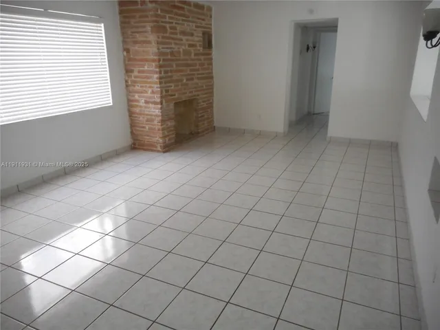 a view of an empty room with windows