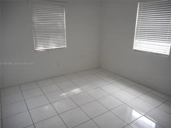 a view of an empty room and a window