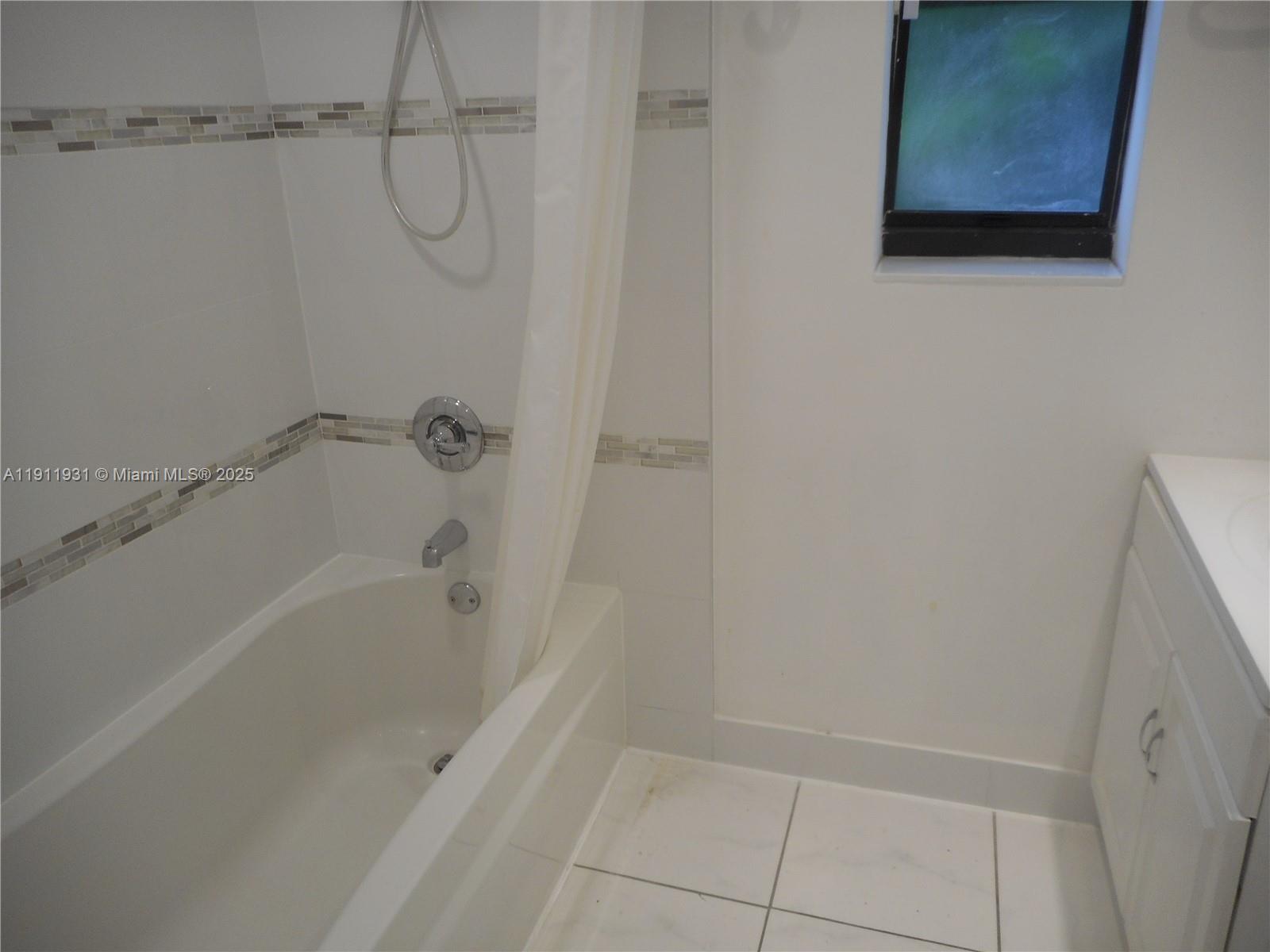 420 88th Street Surfside, FL 33154 - Photo 16 of 19 a bathroom with a bathtub