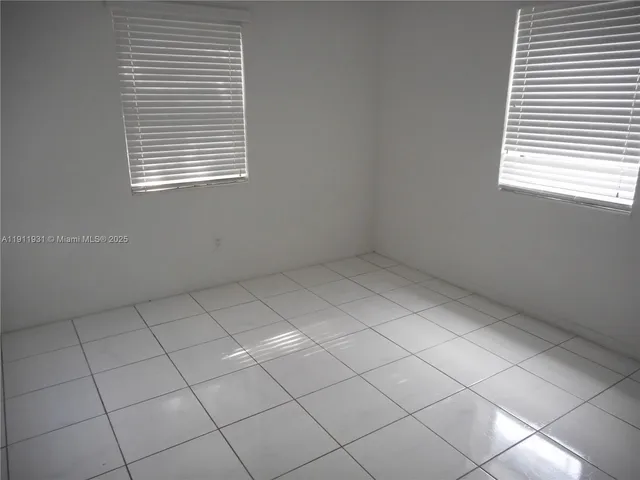 a view of an empty room and a window