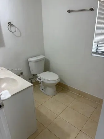 a view of a livingroom with an empty space and a window
