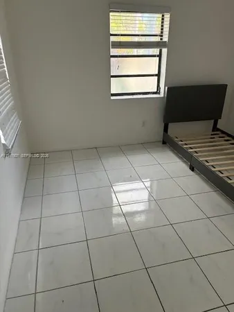 a bathroom with a tub a sink and a window