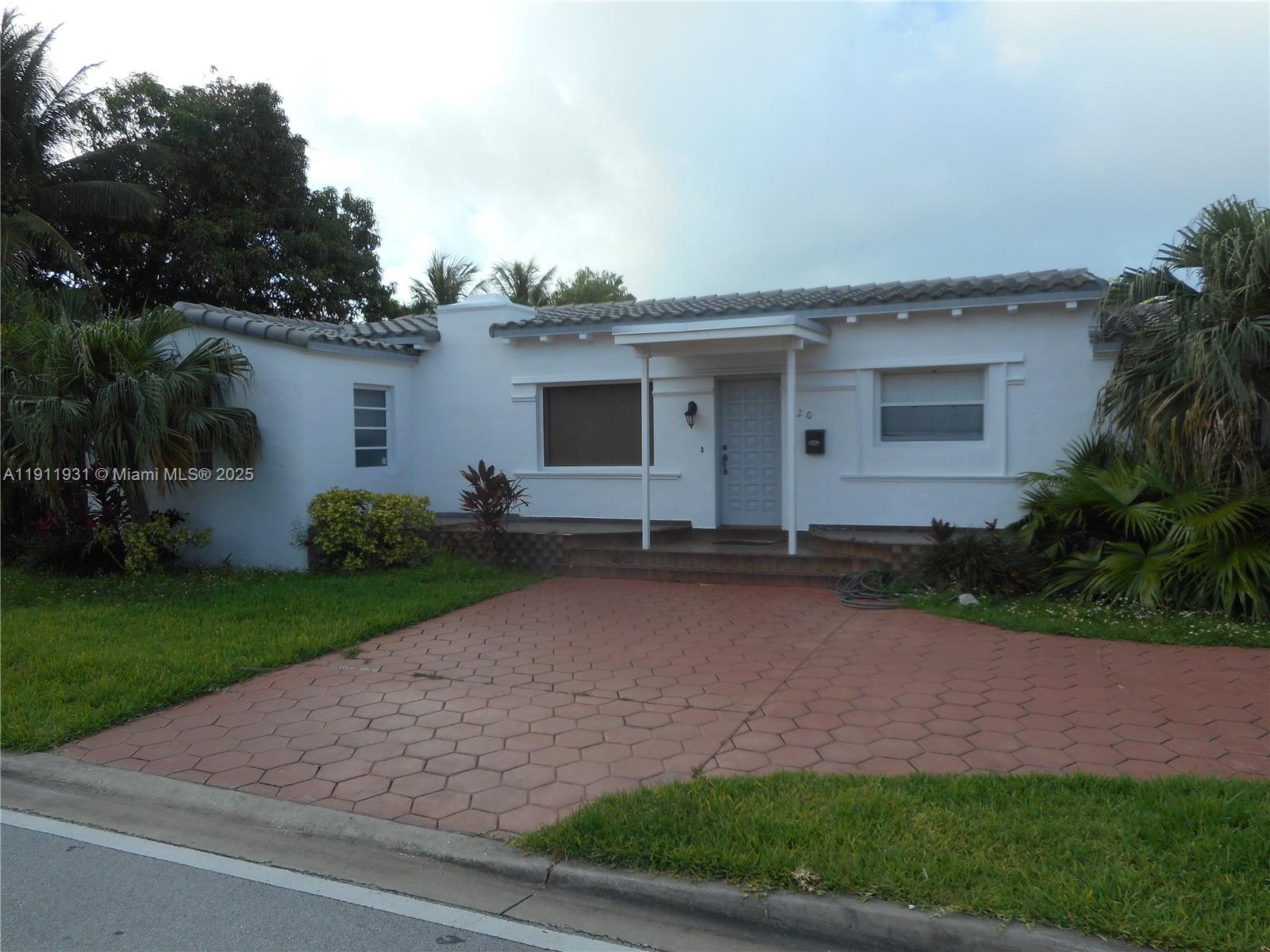 420 88th Street Surfside, FL 33154 - Photo 3 of 19 a front view of house with yard and green space