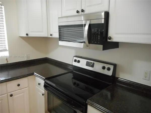 a stove top oven sitting inside of a kitchen