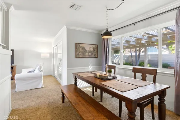 a view of a dining room with furniture window and outside view