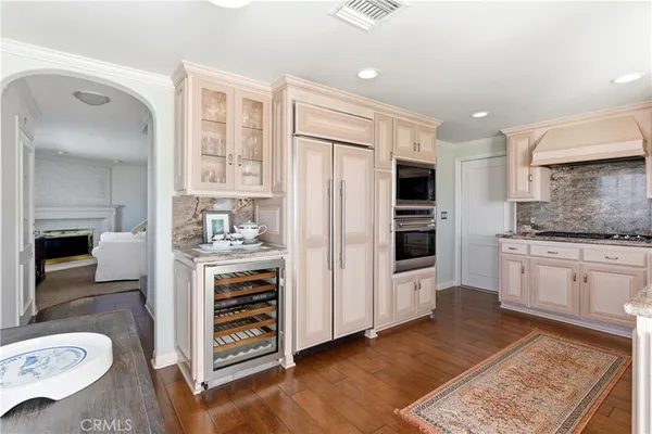 a kitchen with stainless steel appliances kitchen island granite countertop a refrigerator and a stove top oven