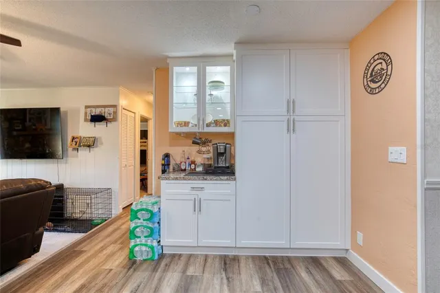 a kitchen with white cabinets and appliances