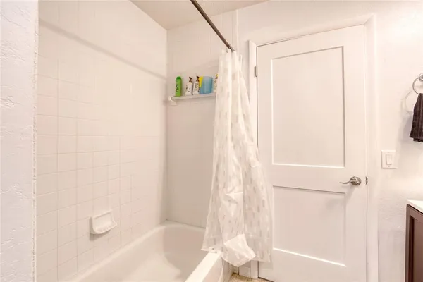 a bathroom with a bathtub and a shower