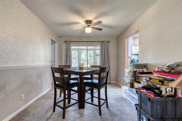 a view of a dining room with furniture and chandelier